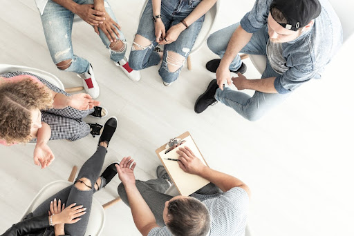 High-angle shot of a group of people sitting in a circle
