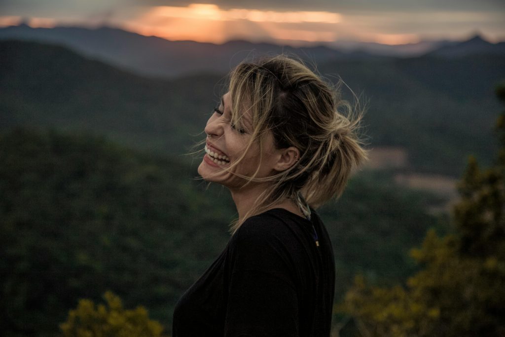 Woman happy watching sunset.